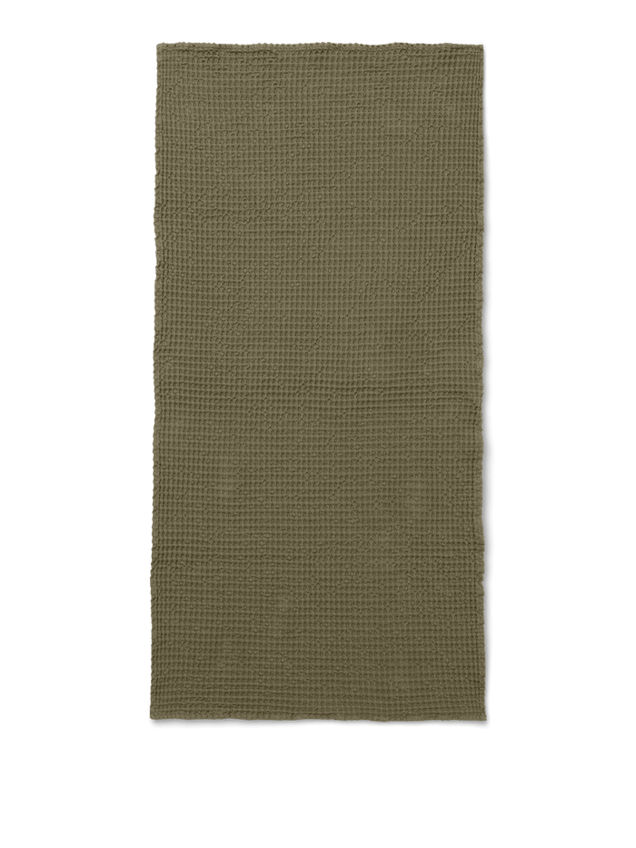 Waffle-textured towel in olive, laid flat